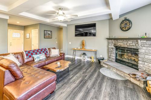 a living room with a couch and a fireplace at Mountain Views and Brook Access Home in Arkville! in Arkville