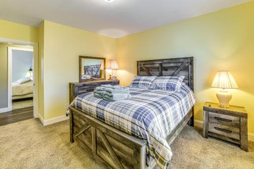 a bedroom with a large bed and a mirror at Mountain Views and Brook Access Home in Arkville! in Arkville