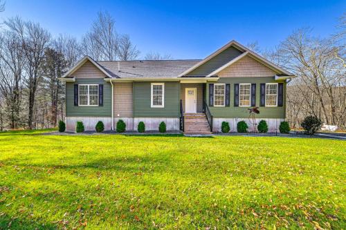 a green house with a green lawn at Mountain Views and Brook Access Home in Arkville! in Arkville