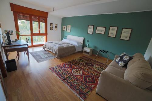 a bedroom with a bed and a couch and a table at A Casa di Sara in Castrovillari