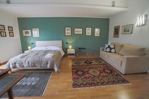 a bedroom with a bed and a couch at A Casa di Sara in Castrovillari