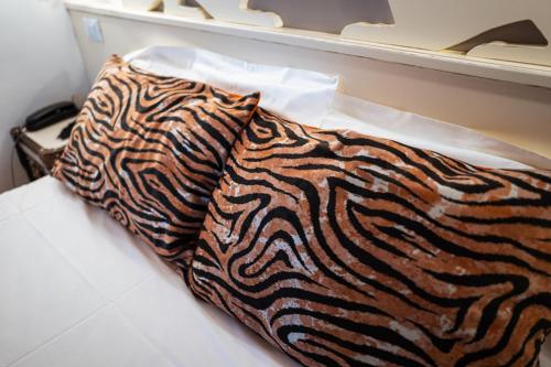 a zebra print pillow sitting on top of a bed at Agriturismo Le Volpi in Baone