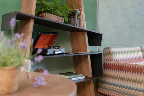 a book shelf with a laptop and a table at Valsana Hotel Arosa - Small Luxury Hotel in Arosa