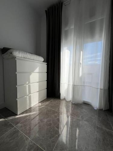 a bedroom with a white dresser and a window at Casa La Fuente Alta in Algodonales