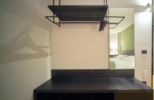 a mirror in a room with a bed and a bedroom at Smart Hotel in Carpi