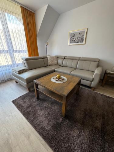 a living room with a couch and a coffee table at Apartmán Vločka Tatranská Lomnica in Tatranská Lomnica