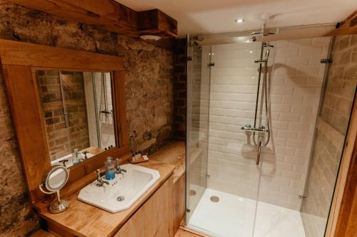 a bathroom with a sink and a shower at Lyde Court Country House in Hereford