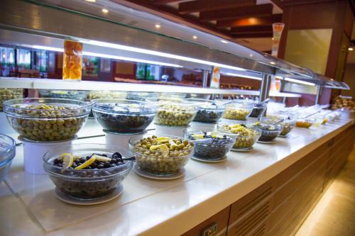 a buffet line with bowls of different types of food at Alder Resort Hotel in Kemer