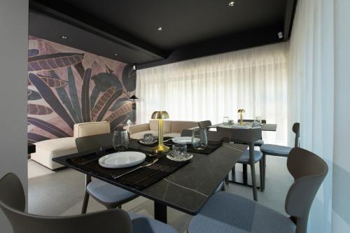 a dining room with a table and chairs at Villa Della Lupa Luxury Rooms in Lecce