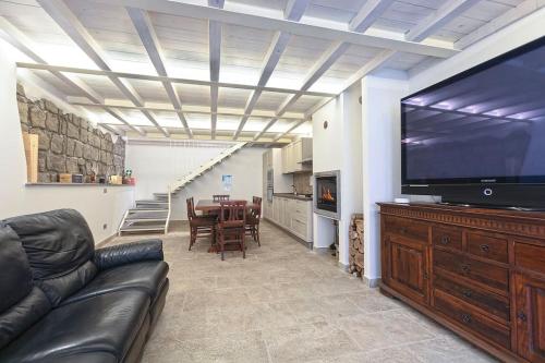 a living room with a couch and a large flat screen tv at Residenza San Marco in Viterbo