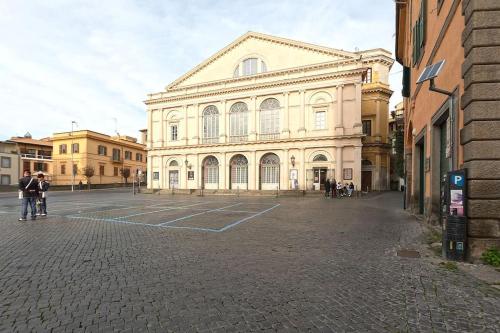 a large building in the middle of a street at Residenza San Marco in Viterbo