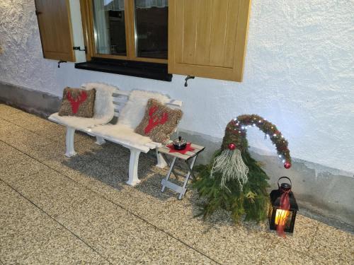 a porch with a bench and a christmas tree at Haus am Bühel in Gaschurn