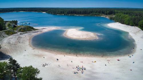 an aerial view of a beach with people in the water at Vakantiehuisje drenthe gasselterveld in Gasselte