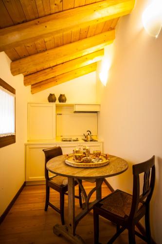 a dining room with a table and two chairs at Agriturismo Le Volpi in Baone