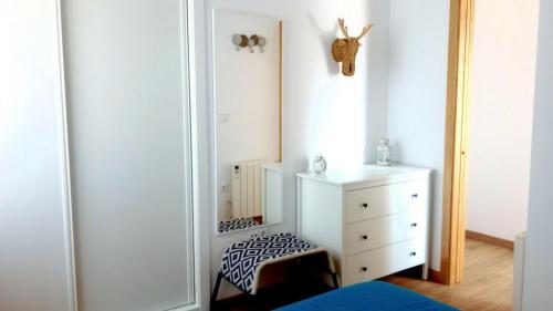 a bedroom with a white dresser and a mirror at Apartamento Teresa in Pontevedra