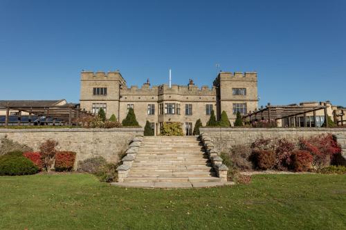 a large castle with a staircase in front of it at Slaley Hall Hotel, Spa & Golf Resort in Slaley