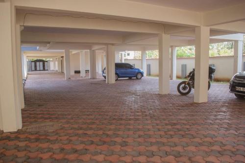 a parking lot with a car parked in a garage at Lulufurnishedapartments in Mombasa