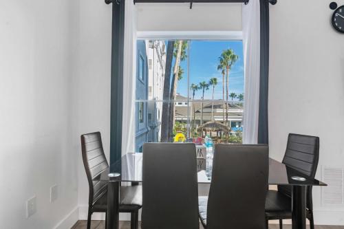 a dining room with a table and chairs and a window at 3 beds DisneyFree Shuttle in Orlando