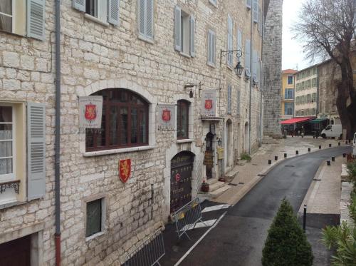 a brick building with a street in front of it at Auberge des Seigneurs in Vence