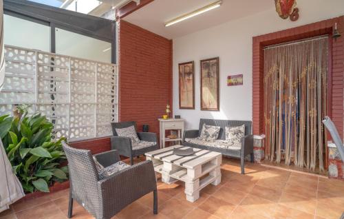 a living room with chairs and a table at Beautiful Home In Torre De Benagalbón in Torre de Benagalbón