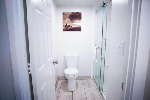 a bathroom with a toilet and a glass shower at The Inn At Tree City, BW Signature Collection in McMinnville