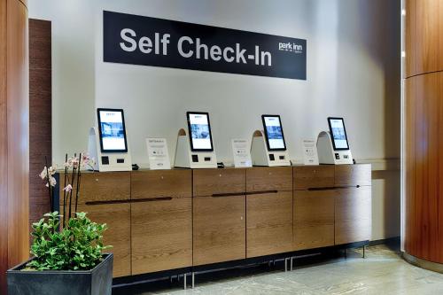 a store counter with computers on top of it at Park Inn by Radisson Berlin Alexanderplatz in Berlin