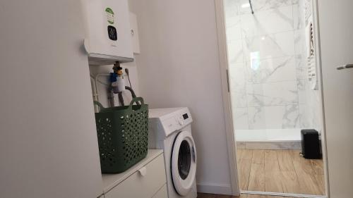 a laundry room with a washing machine and a window at Le nid coco in Hagondange