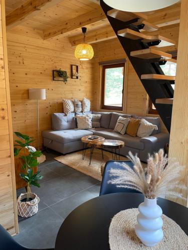 a living room with a couch and a staircase at Pino House Zlatibor-Tornik in Ribnica