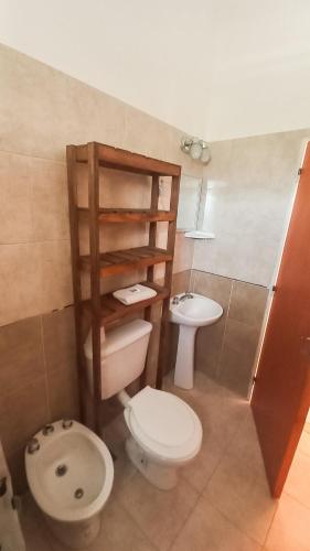 a bathroom with a toilet and a sink at PUEBLO MIO in Cosquín