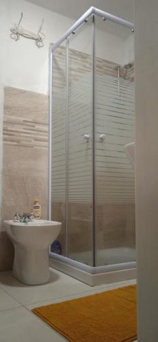 a bathroom with a glass shower and a toilet at La dimora del castagno in Ormea