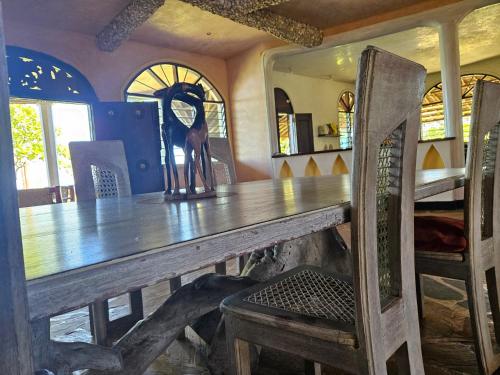 a wooden table in a room with a wooden chair at Wagawimbi Villa 560 m2, Breathtaking View of the Indian Ocean, Kenya in Shimoni