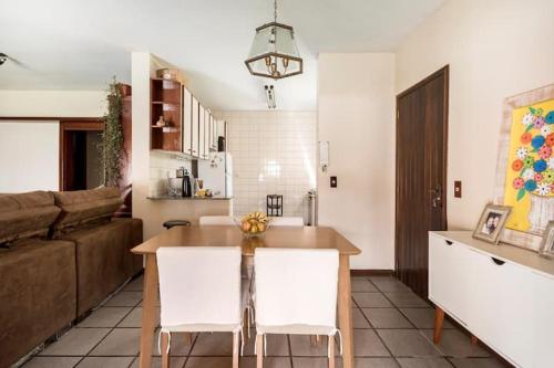 Una cocina y una sala de estar con una mesa y un sofá. en Suíte da Casa da Mi, en Porto Belo