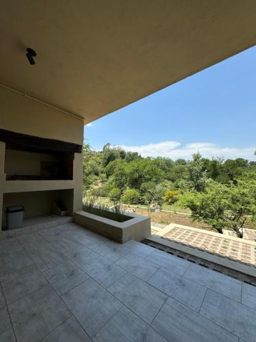 a large patio with a view of the mountains at Cabañas Cuesta in Cordoba