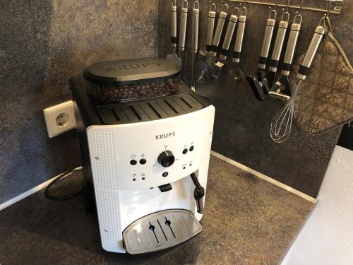 a coffee maker sitting on a counter next to some knives at Das Nest Winterberg in Winterberg