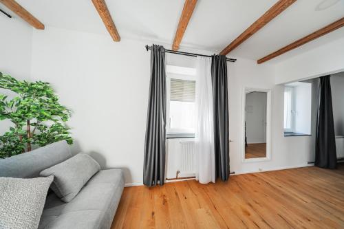 a living room with a couch and a window at Innsbruck City Chalet in Innsbruck