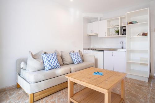a living room with a couch and a table at Bonavida Apartments in Port d'Alcudia
