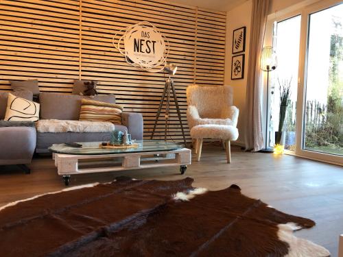 a living room with a couch and a coffee table at Das Nest Winterberg in Winterberg