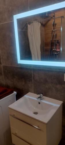 a bathroom with a white sink and a mirror at Apartament Starachowice in Starachowice