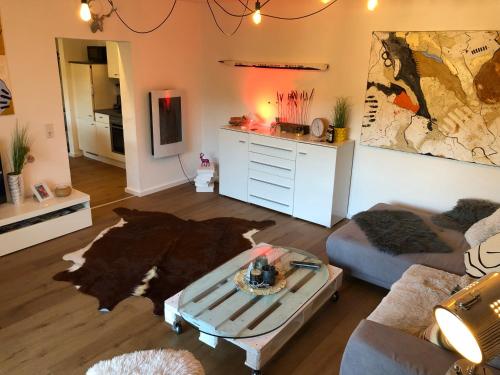 a living room with a couch and a table at Das Nest Winterberg in Winterberg