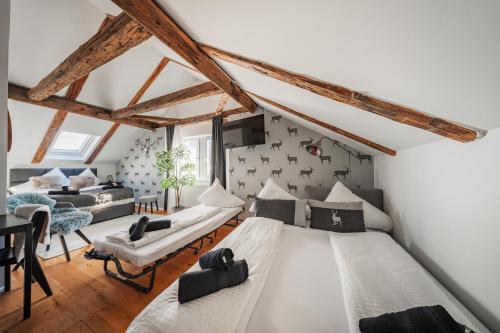 a room with two beds and a living room at Innsbruck City Chalet in Innsbruck