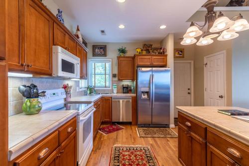 a kitchen with wooden cabinets and a stainless steel refrigerator at Hangin' Out in Blowing Rock