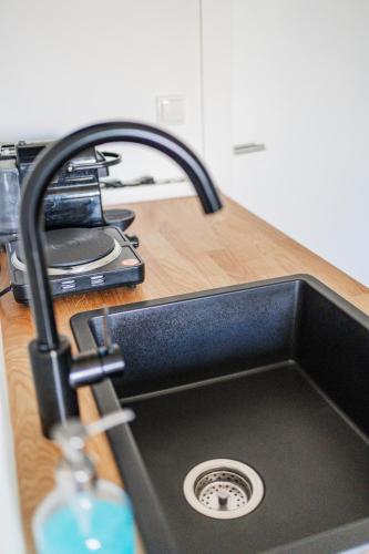 a kitchen sink with a faucet on a counter at Innsbruck City Chalet in Innsbruck