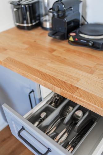 a stove top oven sitting under a wooden counter top at Innsbruck City Chalet in Innsbruck