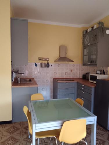 a kitchen with a table and chairs in it at Ilgattonero in Orero