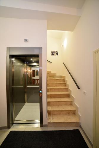 a staircase in a building with a door and a hallway at Il Palazzetto in Bolsena