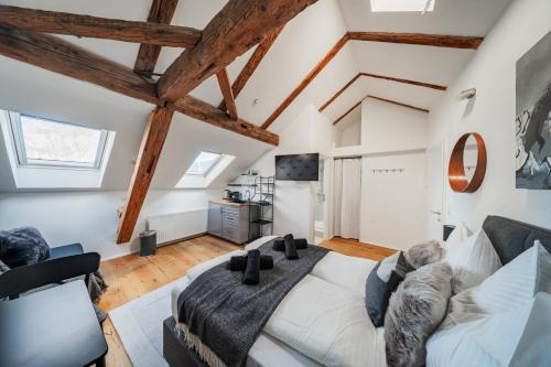 a living room with a large bed and a couch at Innsbruck City Chalet in Innsbruck