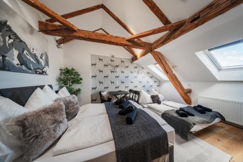 a living room with a white couch and chairs at Innsbruck City Chalet in Innsbruck