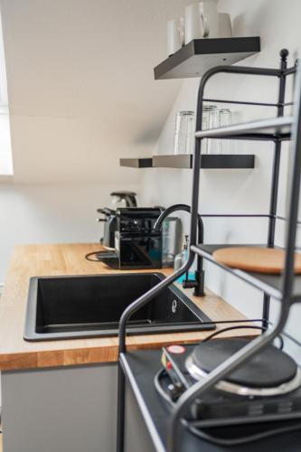 a kitchen counter with a sink and a stove at Innsbruck City Chalet in Innsbruck