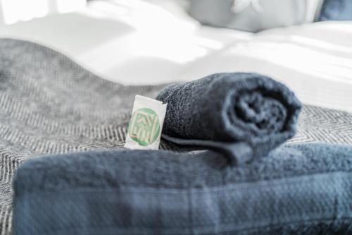 a rolled up towel on top of a bed at Innsbruck City Chalet in Innsbruck