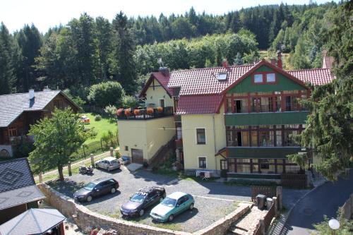 a large house with cars parked in front of it at Kwatery Prywatne-Willa "Nadzieja" in Świeradów-Zdrój